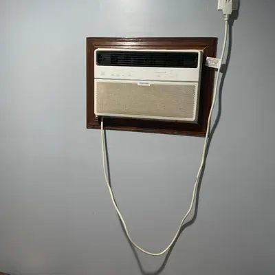 a radio with a cord hanging from a wall at Cozy Room in Bakersfield
