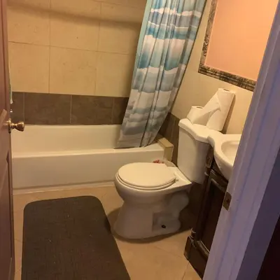 a bathroom with a toilet and a sink at Cozy Room in Bakersfield