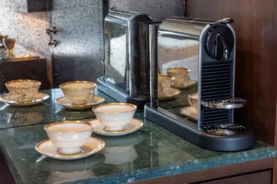 a coffee maker sitting on a counter with cups on plates at Whisky Hotel in Los Angeles