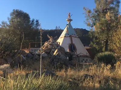 a church with a pile of rocks around it at Big Glamping Teepee in Bodfish