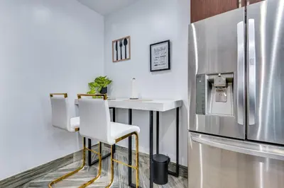 a kitchen with a table and a refrigerator at 7 Mi to Downtown East Los Angeles Apartment in East Los Angeles
