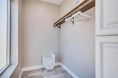 a walk in closet with a white door and tile floor at 7 Mi to Downtown East Los Angeles Apartment in East Los Angeles