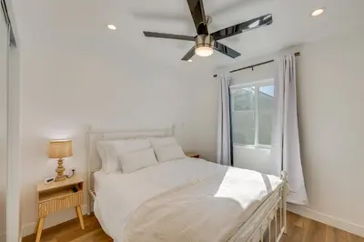 a bedroom with a bed and a ceiling fan at 35 Mi to LA Modern Apartment in Chino! in Chino
