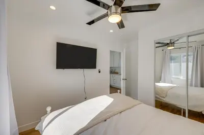 a bedroom with a bed and a flat screen tv at 35 Mi to LA Modern Apartment in Chino! in Chino