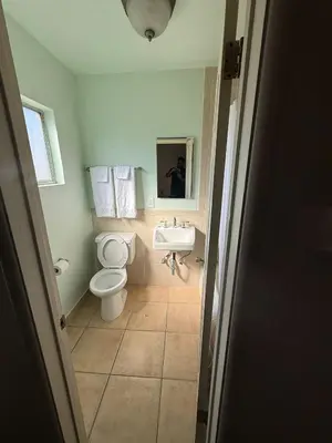 a bathroom with a toilet and a sink at El Rancho Motel, Pasadena in Pasadena