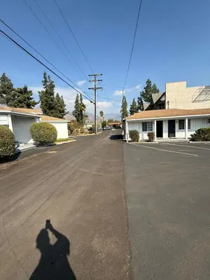 a shadow of a person taking a picture at El Rancho Motel, Pasadena in Pasadena