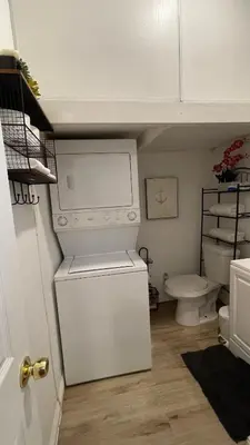 a bathroom with a white refrigerator and a toilet at Private Sanctuary in Montebello in Montebello
