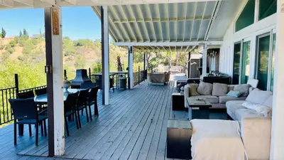 a porch with a couch and a table and chairs at Private Room View Gated 2Acre Estate - Female Share Indoor - Men Share Outdoor - BB in Engine Company Number 109 Heliport