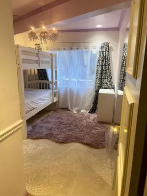 a bedroom with two bunk beds and a chandelier at Private Room View Gated 2Acre Estate - Female Share Indoor - Men Share Outdoor - BB in Engine Company Number 109 Heliport