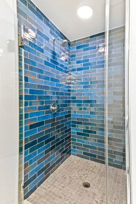 a bathroom with a shower with blue tiles at Modern Hollywood Studio, Pool Parking Gym in Los Angeles