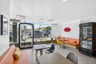 a restaurant with tables and chairs and a car parked in a parking lot at Modern Hollywood Studio, Pool Parking Gym in Los Angeles