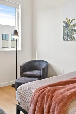 a bedroom with a chair and a bed and a window at Bright Studio on Sunset Blvd Pool, Parking, Gym in Los Angeles