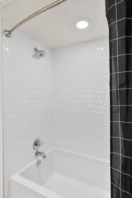 a white bathroom with a shower and a sink at Bright Studio on Sunset Blvd Pool, Parking, Gym in Los Angeles