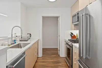 a kitchen with white counters and stainless steel appliances at Mid-Wilshire Studio Free Parking, Pool, Gym in Los Angeles