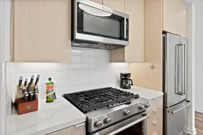 a kitchen with a stove and a microwave at Mid-Wilshire Studio Free Parking, Pool, Gym in Los Angeles
