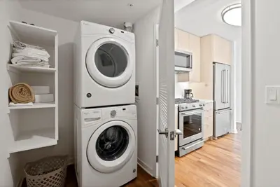 a kitchen with a washer and dryer in a room at Mid-Wilshire Studio Free Parking, Pool, Gym in Los Angeles