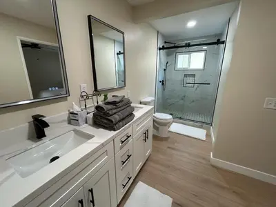 a white bathroom with a sink and a shower at Private Hillside Home with View - Yaamava - NOS in San Bernardino