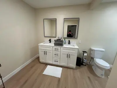 a bathroom with a sink and a toilet and a mirror at Private Hillside Home with View - Yaamava - NOS in San Bernardino