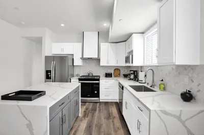 a white kitchen with white counters and white cabinets at LA Rooftop Paradise 2 in Los Angeles