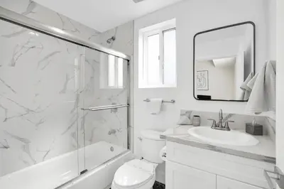 a white bathroom with a shower and a sink at LA Rooftop Paradise 2 in Los Angeles
