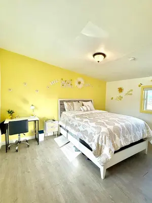 a bedroom with a bed and a desk with a computer at Lemon Studio with Mountain view in Rosemead