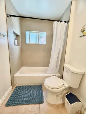 a bathroom with a white toilet and a bath tub at Lemon Studio with Mountain view in Rosemead
