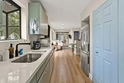 a kitchen with a sink and a refrigerator at Designer Laurel Canyon Retreat, Hollywood Hills in Los Angeles