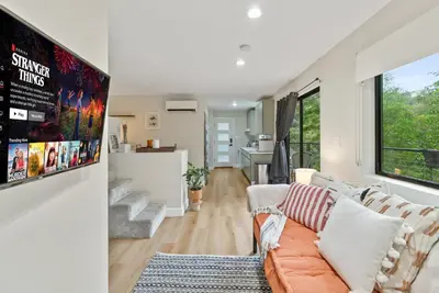 a living room with a couch and a kitchen at Designer Laurel Canyon Retreat, Hollywood Hills in Los Angeles