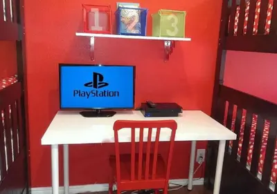 a desk with a computer on a red wall at MagicwayVillas Mickey's Pool Club House - Pool & Spa - Walking to Disneyland in Anaheim