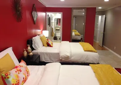 a bedroom with two beds and a red wall at MagicwayVillas Mickey's Pool Club House - Pool & Spa - Walking to Disneyland in Anaheim