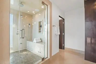 a bathroom with a shower with a glass door at Serene by Stay Awhile Villas in Los Angeles
