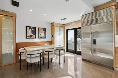 a kitchen with a table and chairs and a refrigerator at Serene by Stay Awhile Villas in Los Angeles