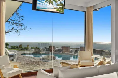 a living room with a large window with a pool at Serene by Stay Awhile Villas in Los Angeles