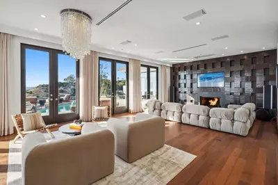 a living room with white furniture and a fireplace at Serene by Stay Awhile Villas in Los Angeles