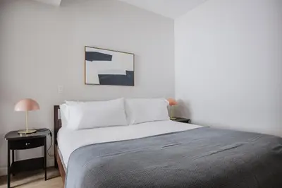 a bedroom with a bed and a lamp on a table at Blueground Downtown elevator nr parks LAX-1239 in Los Angeles