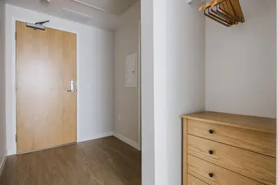 an empty room with a door and a wooden dresser at Blueground Downtown elevator nr parks LAX-1240 in Los Angeles
