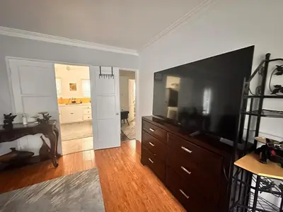 a living room with a large dresser and a bedroom at Del in Los Angeles