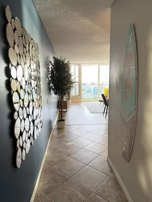 a hallway with a bunch of plates on the wall at Oceanfront 1 BR Oasis w Parking & Pool 107 in Redondo Beach