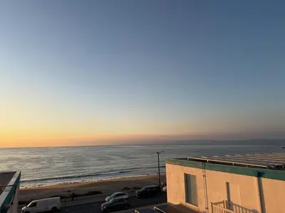 a view of the ocean at sunset from a building at Oceanfront 1 BR Oasis w Parking & Pool 107 in Redondo Beach