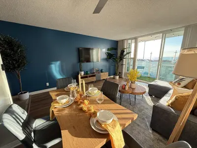 a living room with a wooden table and a blue wall at Oceanfront 1 BR Oasis w Parking & Pool 107 in Redondo Beach