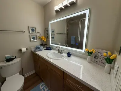 a bathroom with a sink and a mirror at Oceanfront 1 BR Oasis w Parking & Pool 417 in Redondo Beach