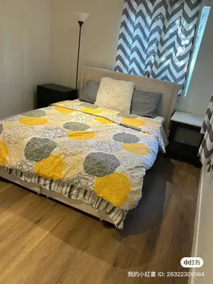 a bed with a quilt on it in a bedroom at Luxury suite private entrance in Hacienda Heights