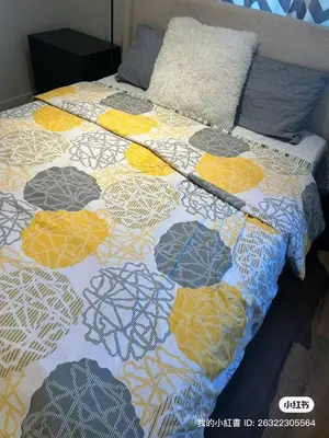 a bed with a colorful quilt on top of it at Luxury suite private entrance in Hacienda Heights