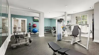 a gym with two treadmills and two mirrors at Style, Peace, Comfort in N Hollywood Next to Burbank Free Indoor Parking and Wifi in Burbank