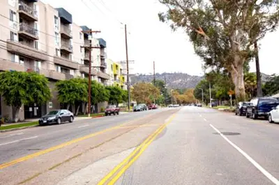 an empty street with cars parked on the road at Style, Peace, Comfort in N Hollywood Next to Burbank Free Indoor Parking and Wifi in Burbank