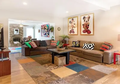 a living room with a couch and a table at Tiki House and Spa - Walking Distance to Dsineyland in Anaheim