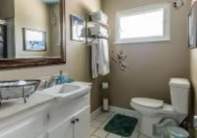 a bathroom with a sink and a toilet and a mirror at MagicwayVillas TeaCup Pool House - Walking Distance to Disneyland in Anaheim