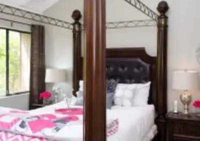 a bedroom with a large bed with a wooden frame at MagicwayVillas Micky's Fireworks Pool & Spa - Across Disneyland in Anaheim