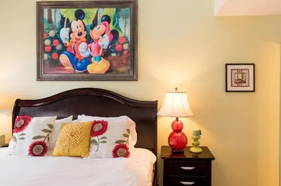 a bedroom with a bed and a painting on the wall at Magicwayvillas Micky's Playground Pool & Spa - Walking TO Disney in Anaheim