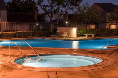 a small swimming pool in a yard at night at Magicwayvillas Micky's Playground Pool & Spa - Walking TO Disney in Anaheim